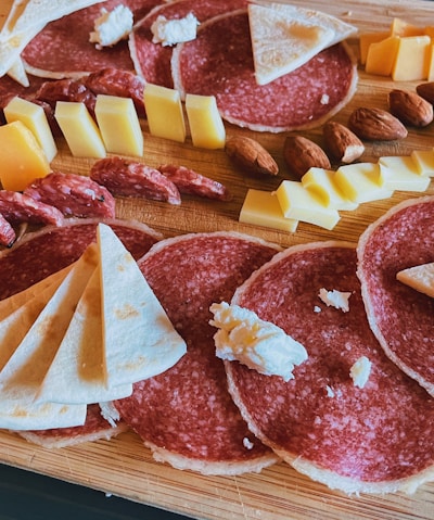 sliced meat on brown wooden chopping board